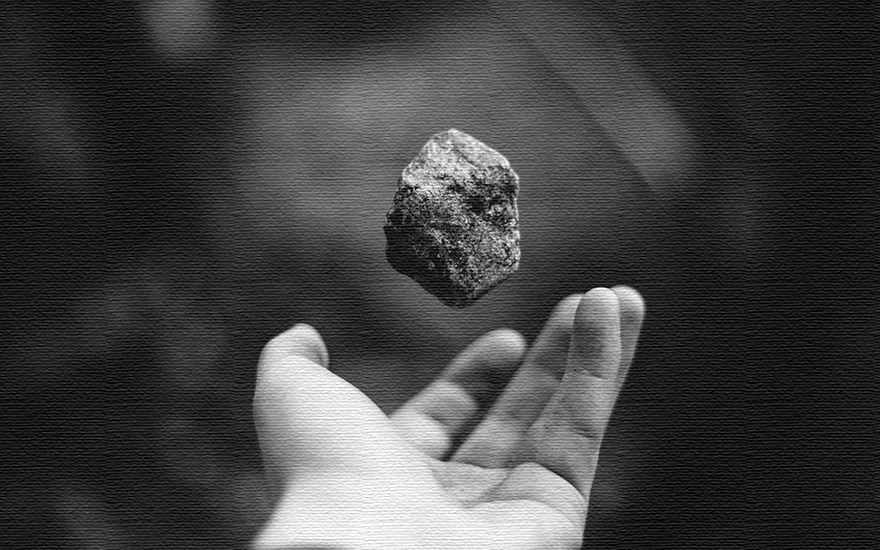 Image of a stone floating above a hand